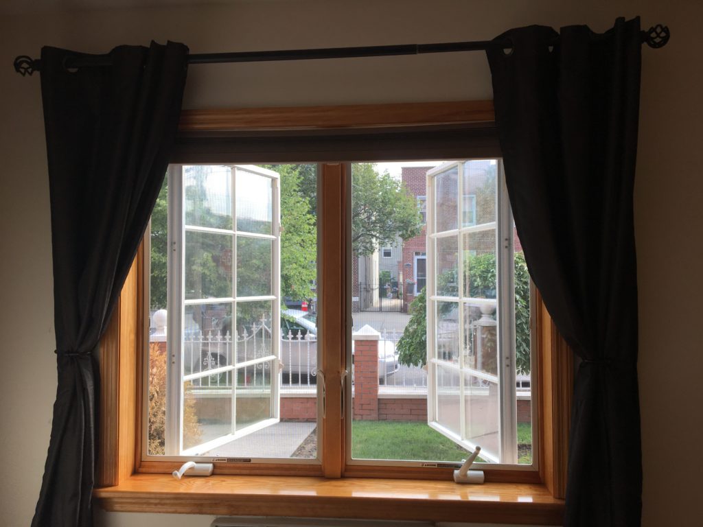 Combining outside-mounted blackout curtains with inside-mounted blackout blinds.